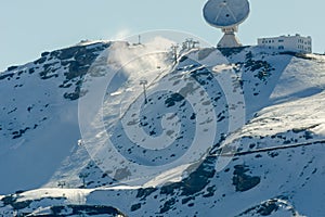 View of the ski resort in the high snowy mountains next to the astronomical observatory, listening in the cosmos.