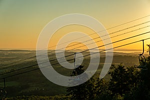 View of the ski slope and the lift at dawn. Wonderful winter mountain morning landscape