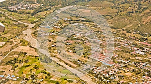 View from the sky of a landscape of mountains, settlements and rice fields