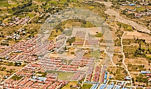 View from the sky of a landscape of mountains, settlements and rice fields