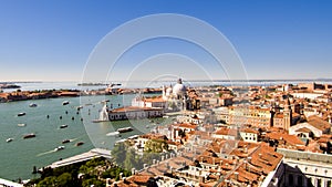 A view of the skyline overlooking the old town and canals of Venice, Italy on a sunny clear day.