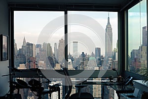 View of skyscrapers of New York City Manhattan through windows of apartment. Top view of midtown of Manhattan.