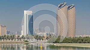 View of skyscrapers skyline with Al Bahr towers in Abu Dhabi timelapse. United Arab Emirates