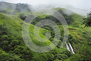 A view of Slide Waterfall, also known as Catarata El Tobogan, can be seen from the hiking trail at Viento Fresco in Costa Rica. photo