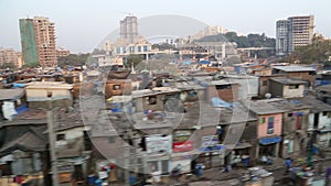 View on slum in Mumbai during a train ride.
