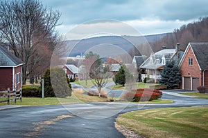 View of small American town residential complex district with houses a roads from with trees