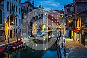 View into a small canal in Venice at night