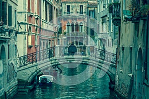 View into a small canal in Venice at night