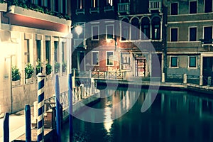 View into a small canal in Venice at night