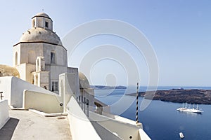 View of small chapel and cruise ship at santorini, greece