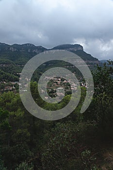 View of the small city of Gallifa and its mountains in Catalonia, Spain during a storm at dawn