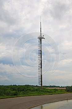 View of a small communications tower on a cloudy day