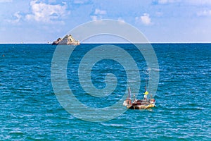 View of small fishing boat and small island at Koa Samed or Koh