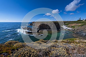 View of the small fishing port of Entrada da Barca from the surrounding cliffs, at Zambujeira do Mar in Odemira photo