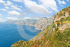 View of small house in mountains by sea