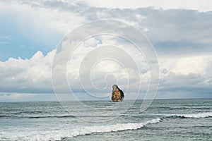 View of small island in the middle sea againts sky