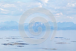 View of small islets and mountains seen far on the other side of the fjord