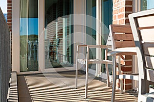 View of a small modern balcony with chairs during daylight