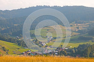 View of a small mountain village on an autumn sunny day.