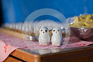 View of small pair of white owl salt and pepper shakers