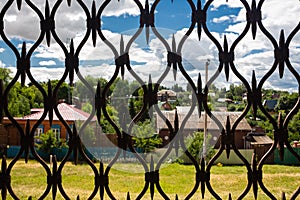 View of a small provincial town through a lattice of the fortress gates