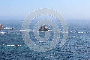 View of a small rock island in the Pacific Ocean close to Pacific Coast Highway, California, USA