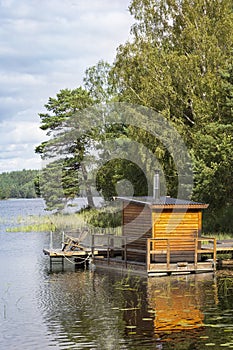 View of a small sauna by a lake, on a jetty