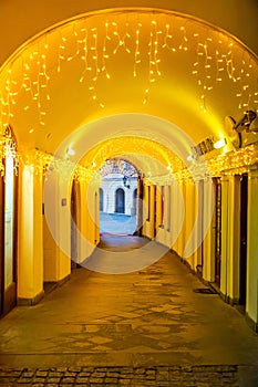 View of a small street in the courtyard with houses decorated with Christmas lights in the old center of Prague, Czech