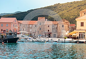 View of a small town center of the town Starigrad at Hvar island. Old small boats in the water as life goes on in a small village