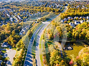 View of a small town with low-rise houses in Virginia USA. Drone view of the autumn landscape with a road