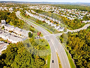 View of a small town with low-rise houses in Virginia USA. Drone view of the autumn landscape with a road