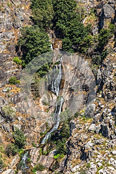 View of small waterfall, slit in the Paiva river slope and water flowing through the rocks