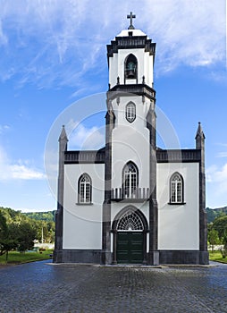 View of small white and gray church of Sao Nicolau at the village of Sete Cidades on the island of Sao Miguel, Azores