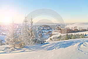 View of small winter town at sunset from hilltop