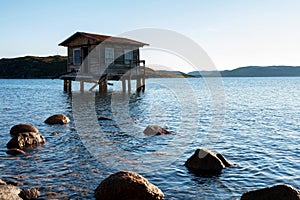 View of small wooden house on stilts in a bay of Dalniye Zelentsy