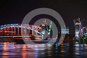 View of Smolny Cathedral through the divorced Bolsheokhtinsky bridge at night. Saint Petersburg