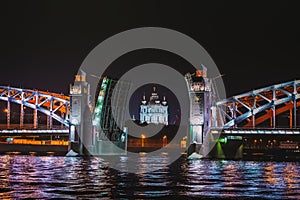 View of Smolny Cathedral through the divorced Bolsheokhtinsky bridge at night. Saint Petersburg