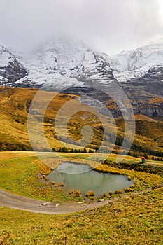 View of snow alp mountain landscape in autumn nature at swiss from the train