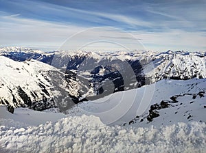 View of the snow-capped peaks of the rocky mountains. Scenery of alpine landscape in winter