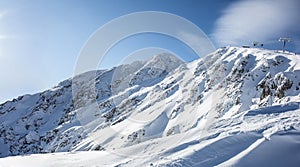 View of the snow-covered hills of the Low Tatras - Jasna and the cable car that takes skiers to Chopok mountain