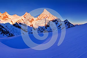 View of snow covered landscape with Dent Blanche mountains and Weisshorn mountain in the Swiss Alps near Zermatt. Panorama