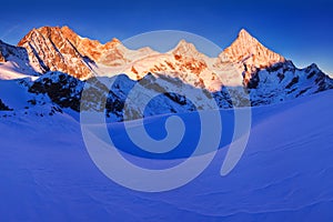 View of snow covered landscape with Dent Blanche mountains and Weisshorn mountain in the Swiss Alps near Zermatt. Panorama
