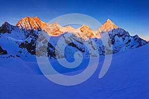 View of snow covered landscape with Dent Blanche mountains and Weisshorn mountain in the Swiss Alps near Zermatt. Panorama