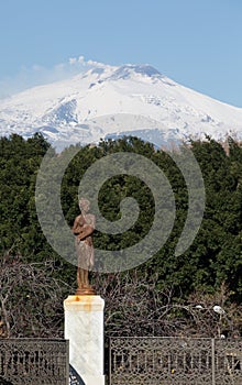 View of snow covered Mount Etna from Giardino Bellini in Catania, Sicily photo