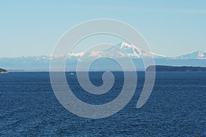 View on snow covered mountain from merchant vessel approaching Vancouver, British Columbia  from Pacific ocean.