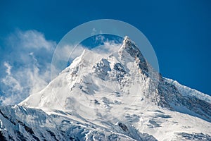 View of snow covered peak of Mount Manaslu 8 156 meters with clouds in Himalayas, Detail of snowy peak.