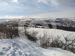 view of the snow-covered town of Kezmarok, where the High Tatras are in the background