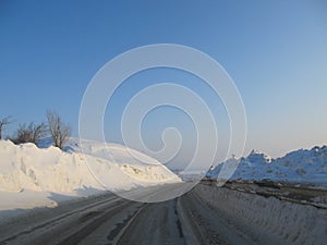 View of the snow-covered track from the windshield of the car