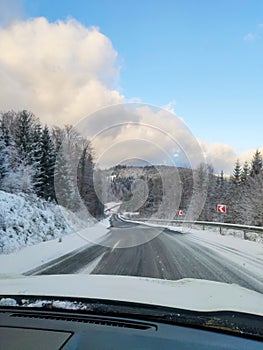 view of snowed road in mountains range car travel concept