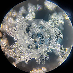 View on snowflake under microscope ocular